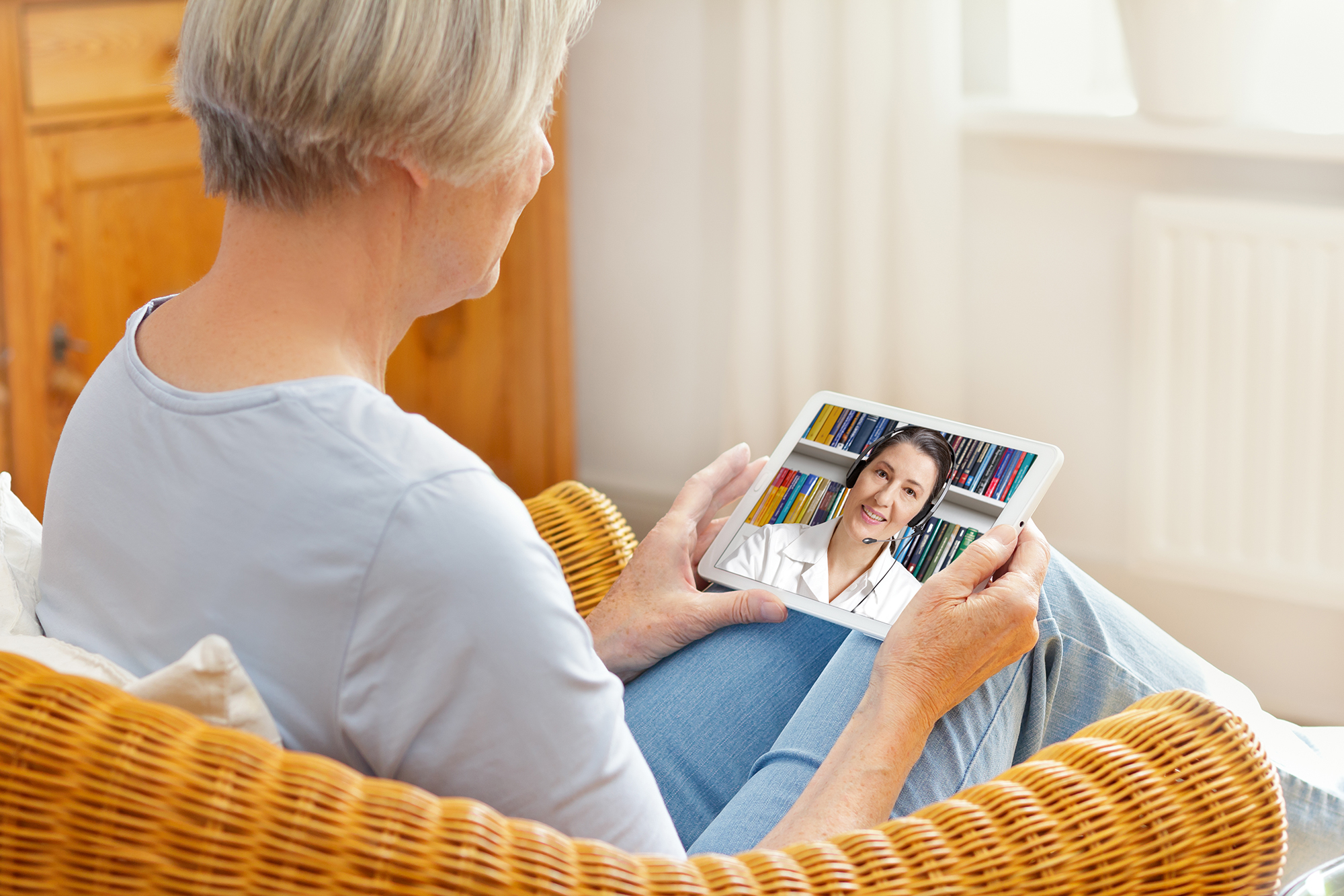 Senior Woman With Tablet Pc During An Online Consultation